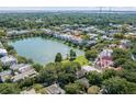 Aerial view of a neighborhood with houses surrounding a pond at 106 W Shipyard Rd, Mount Pleasant, SC 29464