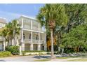 Two-story house with white exterior, balconies, and palm trees at 106 W Shipyard Rd, Mount Pleasant, SC 29464