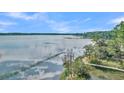 Aerial view of waterfront property with a wooden dock and calm water at Lot 93 Lady Banks Ln, Hollywood, SC 29470