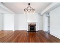 Bright dining room with hardwood floors, fireplace, and chandelier at 106 Church St # D, Charleston, SC 29401