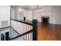 Open living area with hardwood floors, two fireplaces, and high ceilings at 106 Church St # D, Charleston, SC 29401