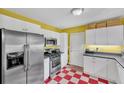 Charming kitchen boasts modern appliances and red and white checkered floors at 148 Chadwick Dr, Charleston, SC 29407