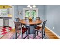 Bright dining room features a round table with chairs and access to the kitchen at 148 Chadwick Dr, Charleston, SC 29407