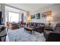Spacious living area featuring hardwood floors, leather sofas, and water views at 14 Lockwood Dr # 10D, Charleston, SC 29401