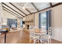 Open living area with vaulted ceiling, exposed beams, and brick fireplace at 525 Parkdale Drive, Charleston, SC 29414