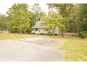 Cute white cottage with a large driveway and wood fence at 309 Wintergreen Rd, Walterboro, SC 29488