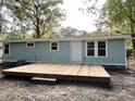 Newly renovated light blue house with large deck and mature trees at 861 Savage Rd, Charleston, SC 29414