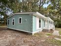 Side view of charming light blue house with white trim and porch at 861 Savage Rd, Charleston, SC 29414