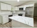 Modern kitchen with white cabinets, stainless steel appliances, and quartz countertops at 861 Savage Rd, Charleston, SC 29414