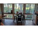 Sunroom with table and chairs, offering scenic views of the outdoors at 818 Club Cottage Court, Edisto Beach, SC 29438