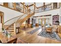 Grand entryway with hardwood floors, curved staircase, and built-in cabinetry at 1408 Palmetto Blvd, Edisto Island, SC 29438