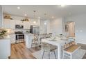 Modern kitchen with island and white cabinets at 101 Clarabelle Ln, Summerville, SC 29483