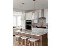 Modern kitchen with white cabinets, quartz countertops, and an island with seating at 424 Grove End Rd, Moncks Corner, SC 29461