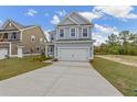 Two-story Craftsman home with gray siding, white trim, and a two-car garage at 424 Grove End Rd, Moncks Corner, SC 29461