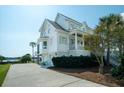 Side view of home with garage and landscaping at 1531 Murphys Island Ct, Awendaw, SC 29429