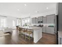 Modern kitchen with gray cabinets, granite countertops, and an island with seating at 1093 Keeper Ln, Summerville, SC 29485