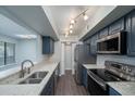 Updated kitchen featuring stainless steel appliances and blue cabinets at 1481 Center Extension St # 208, Mount Pleasant, SC 29464