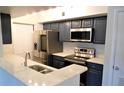 Modern kitchen with stainless steel appliances and white quartz countertops at 1481 Center Extension St # 208, Mount Pleasant, SC 29464