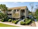 Two-story condo with multiple balconies, lush landscaping, and a walkway at 1640 Live Oak Park, Seabrook Island, SC 29455