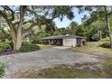 Ranch home with attached garage and large shade trees at 205 Whitesville Rd, Moncks Corner, SC 29461