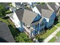 Aerial view of a light blue house with a gray roof and a porch at 208 Sweetspire Ln, Summerville, SC 29483