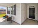 Inviting front porch with two wicker chairs and a small table at 706 Squire Pope Rd, Summerville, SC 29486