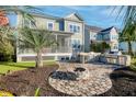 Outdoor kitchen, fire pit, and screened porch in a beautifully landscaped backyard at 1174 Ayers Plantation Way, Mount Pleasant, SC 29466