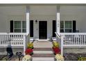 Front porch with rocking chairs, flower pots and black front door at 1746 Pierpont Ave, Charleston, SC 29414