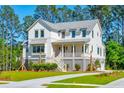 Two story farmhouse style home with gray accents and a large yard at 1480 Jeremy Cay Ct, Awendaw, SC 29429
