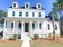 White two-story house, front porch, landscaping at 3869 Delinger Dr, Mount Pleasant, SC 29466
