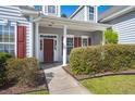 Front entry with red shutters and a welcoming porch at 399 Decatur Dr, Summerville, SC 29486