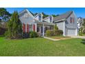 Gray siding two-story house with red shutters and attached garage at 399 Decatur Dr, Summerville, SC 29486