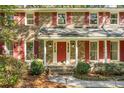 Front view of a two-story brick home with red shutters and a red door at 112 Huckleberry Ln, Summerville, SC 29485