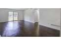 Bright living room featuring dark brown wood-look flooring and access to a patio at 809 Andrea Ln, Hanahan, SC 29410