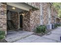 Exterior view of building entrance with brick facade, metal staircase, and landscaping at 809 Andrea Ln, Hanahan, SC 29410