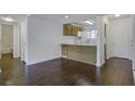 Open concept kitchen with wood cabinets, white appliances, and dark brown flooring at 809 Andrea Ln, Hanahan, SC 29410