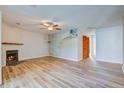 Living room with fireplace, wood-look floors, and ceiling fan at 607 Waterwood Dr, Goose Creek, SC 29445