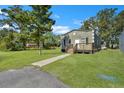Front view of a charming bungalow with a grassy yard and walkway at 1910 Kerry St, North Charleston, SC 29406