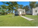 Front view of a charming bungalow, showcasing the front porch and yard at 1910 Kerry St, North Charleston, SC 29406