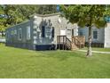 Side view of a charming bungalow with a grassy yard at 1910 Kerry St, North Charleston, SC 29406