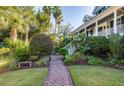 Brick pathway leading to home with tropical plants at 1311 S Jenkins Lagoon Dr, Seabrook Island, SC 29455