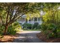 House with wrap around porch and mature trees at 1311 S Jenkins Lagoon Dr, Seabrook Island, SC 29455