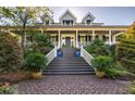 Grand home entrance with brick stairs and landscaping at 1311 S Jenkins Lagoon Dr, Seabrook Island, SC 29455