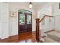 Bright entry with hardwood floors, elegant staircase, and double doors leading outside at 738 Hibbens Grant Blvd, Mount Pleasant, SC 29464