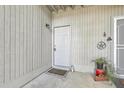 Front door entry with a welcome mat and potted plant at 202 Greenmeadow Dr, Goose Creek, SC 29445