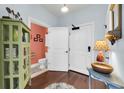 Entryway with hardwood floors, powder room, and coat closet at 33 Calhoun Street Apt. 123, Charleston, SC 29401