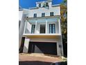 Three-story house with a two-car garage and front porch at 22 Iron Forge Aly, Charleston, SC 29403