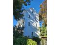 Three-story light gray house with white trim and several windows at 22 Iron Forge Aly, Charleston, SC 29403