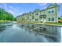 Row of townhouses in varying colors, offering ample parking at 801 Twin Rivers Dr, Wando, SC 29492