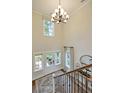 Elegant two-story foyer with a chandelier, hardwood floors, and a view to the backyard at 107 Grange Cir, Summerville, SC 29486